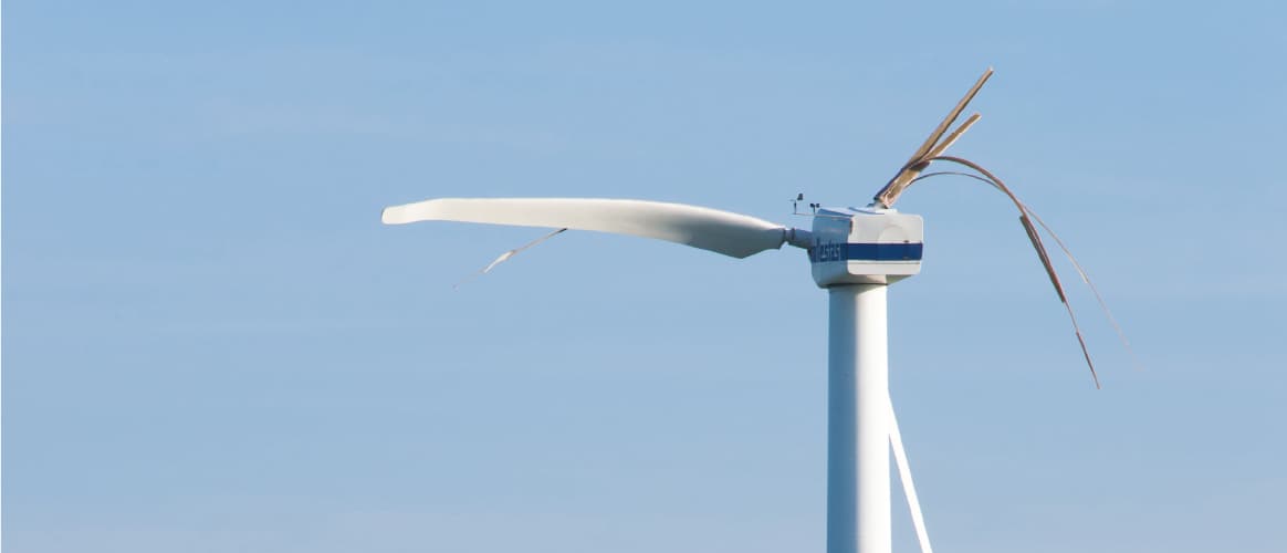 A broken wind turbine requires maintenance