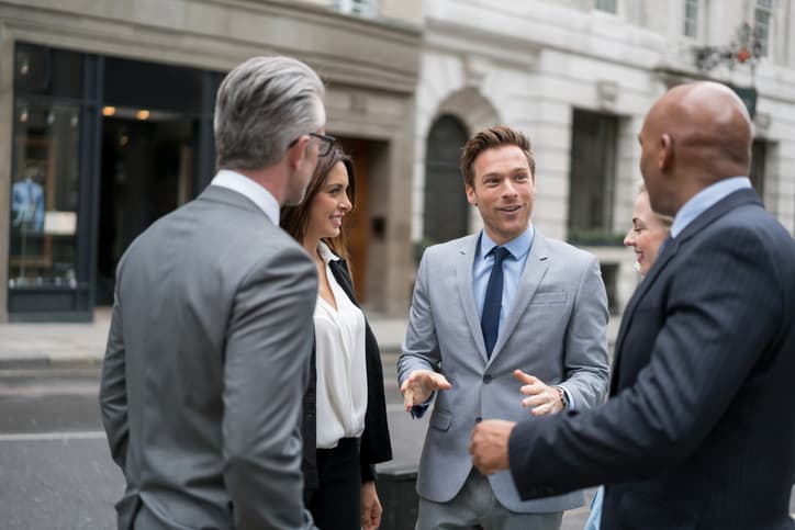 Successful group of business people talking on the street