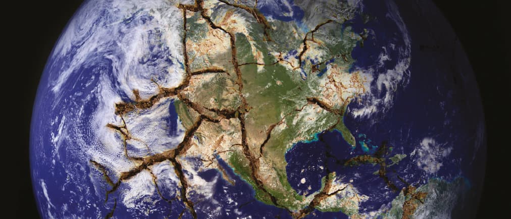 The earth viewed from space with fault lines cracking the surface