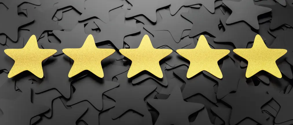 Five gold stars in a line on a background of black stars